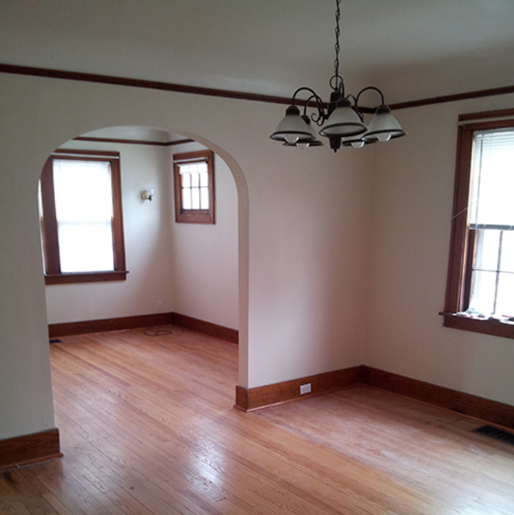 A room with wooden floors and a chandelier.